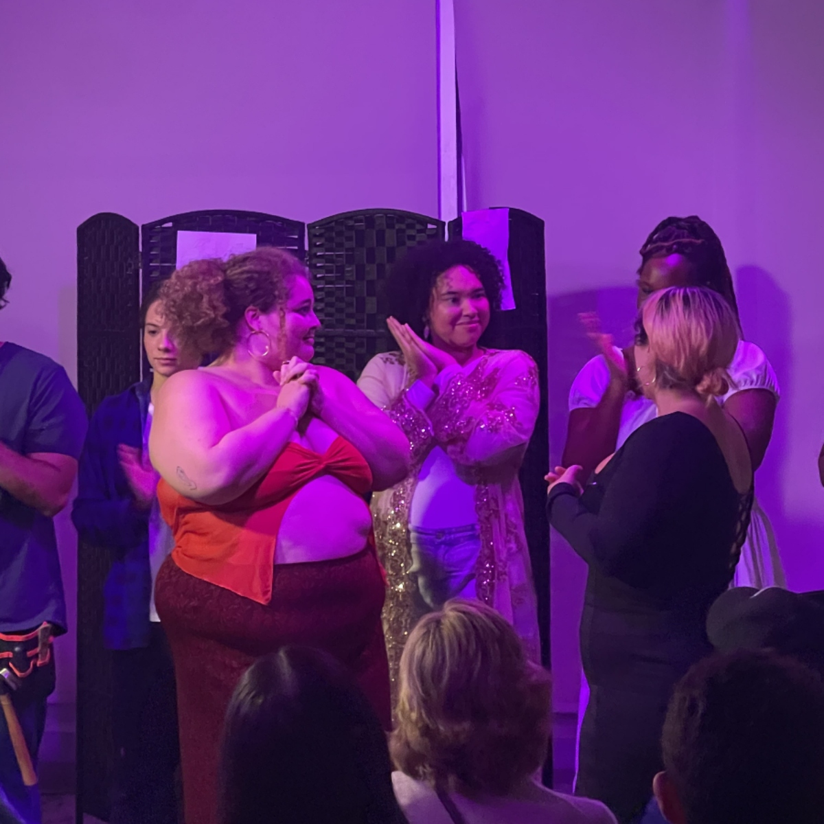 A candid photo of Amelie with 
                        Pinky and cast members at a showing of her play, Gathering.